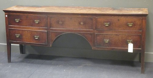 Lot 330 - An George III elm kneehole dresser with five...