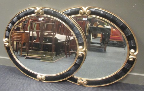 Lot 460 - A pair of Christopher Guy oval wall mirrors,...