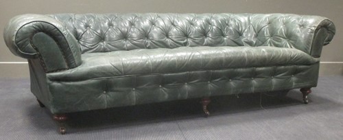 Lot 352 - A green leather Chesterfield settee 68x242x107cm
