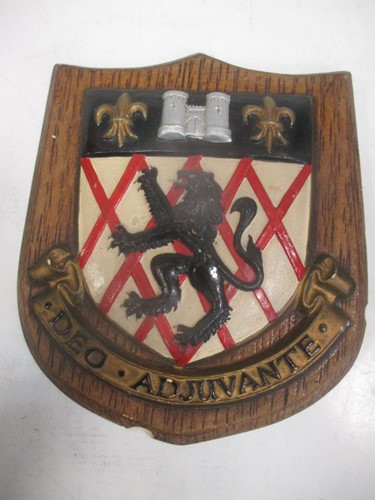 Lot 23 - An early 20th century painted armorial shield...