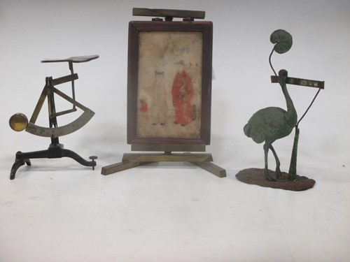 Lot 33 - A patinated metal menu holder modelled as an...