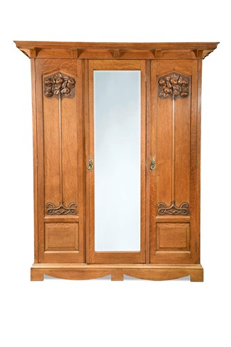Lot 123 - An Arts & Crafts oak triple wardrobe, circa 1900