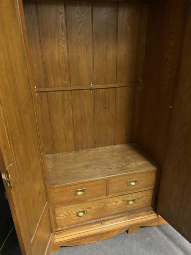 Lot 123 - An Arts & Crafts oak triple wardrobe, circa 1900