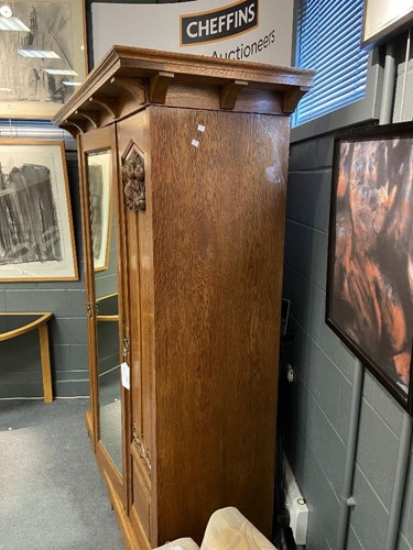 Lot 123 - An Arts & Crafts oak triple wardrobe, circa 1900