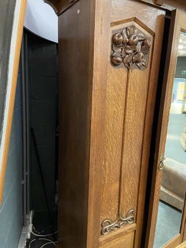Lot 123 - An Arts & Crafts oak triple wardrobe, circa 1900
