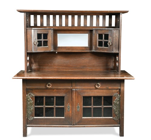 Lot 129 - An Arts & Crafts oak sideboard in the manner of Liberty & Co.