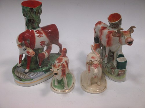 Lot 96 - A Staffordshire pottery spill holder with cow...
