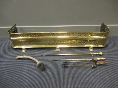 Lot 422 - A Victorian brass fender with pierced...