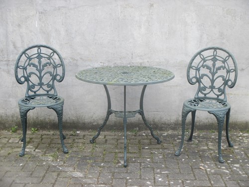 Lot 426 - A metal green painted circular garden table...