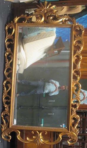 Lot 675 - A large Italian style giltwood wall mirror,...