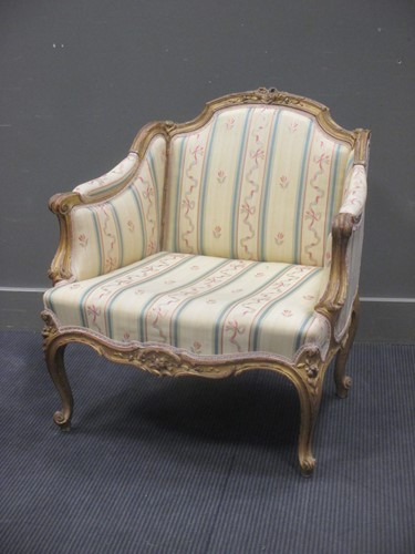 Lot 367 - A Louis XV/XVI style carved gilt wood bergère,...
