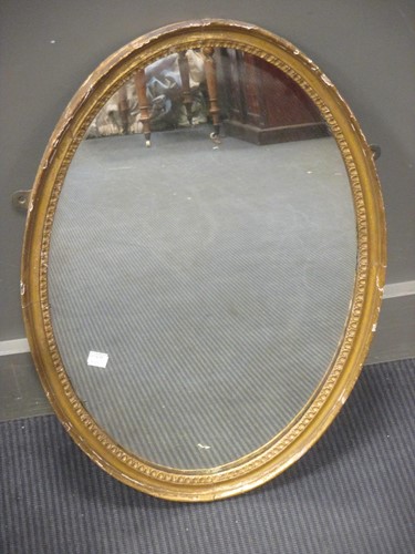 Lot 385 - A George III style oval carved gilt wood wall...