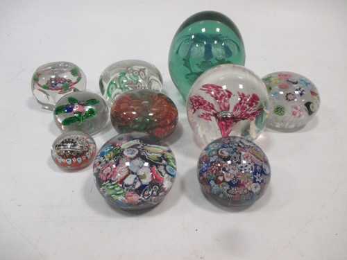 Lot 145 - A collection of ten glass dump paper weights,...