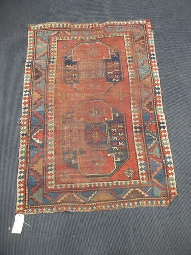 Lot 494 - A red ground geometric tribal rug 167 x 113cm...