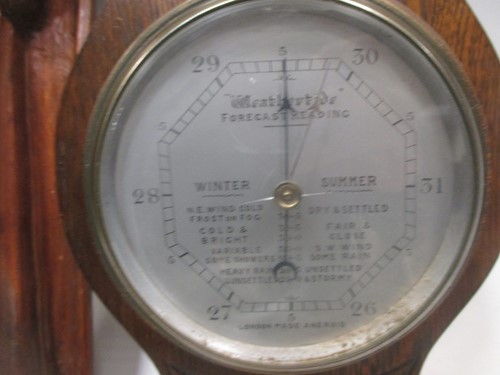 Lot 57 - An aneroid barometer, another barometer, a...
