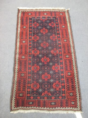 Lot 486 - An early twentieth century Beluchi rug