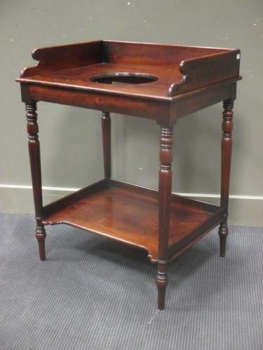 Lot 401 - A George III mahogany two tier washstand on...