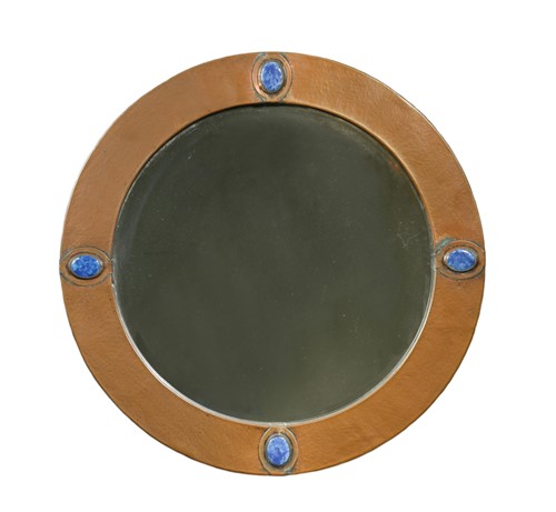 Lot 121 - An Arts & Crafts copper framed circular wall mirror
