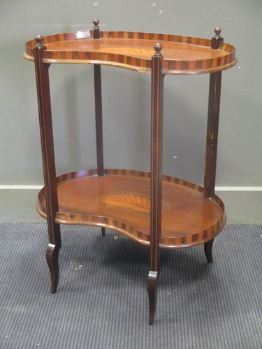 Lot 559 - An inlaid mahogany two tier kidney shape stand,...