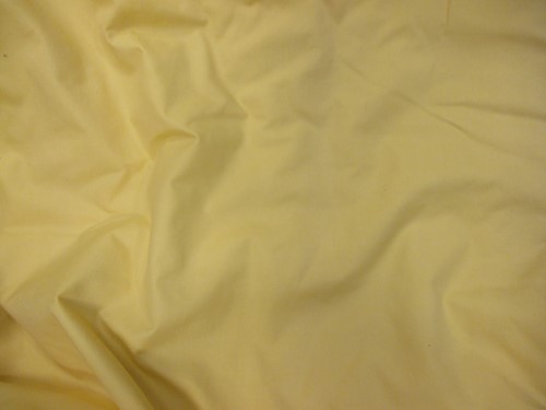 Lot 440 - One pair of yellow cotton curtains, lined and...