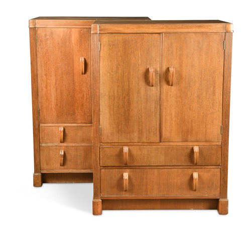 Lot 148 - Fyne Ladye for Heal's, a pair of oak Odeonesque tallboys