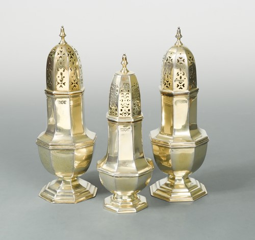 Lot 441 - A near pair of early 20th century silver gilt sugar casters and another