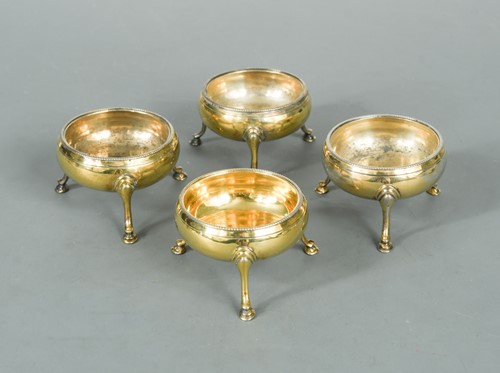 Lot 407 - A set of four George III 18th century silver gilt cauldron salts