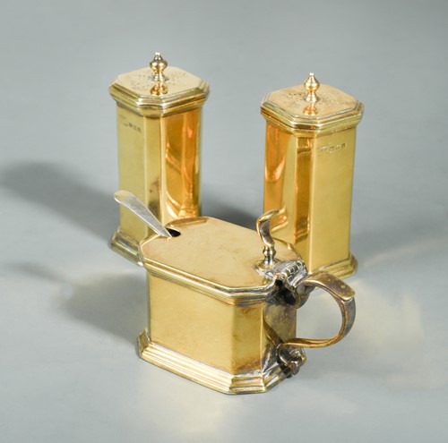 Lot 462 - A George V silver gilt three-piece condiment set