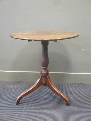 Lot 424 - A 20th century oak tripod table, the circular...