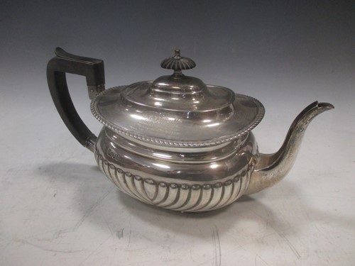 Lot 185 - A silver half gadrooned teapot with...