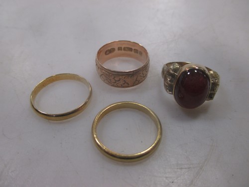 Lot 215 - A collection of four rings including a...