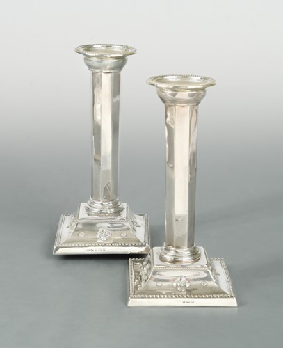 Lot 437 - A pair of Edward VII silver candlesticks, mark of Liberty & Co.