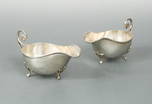Lot 452 - A pair of George V silver sauce boats, mark of A.E. Jones and retailed by Asprey