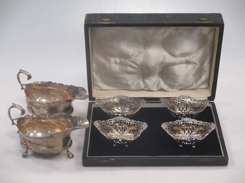 Lot 177 - A pair of early 20th century silver cream jugs...