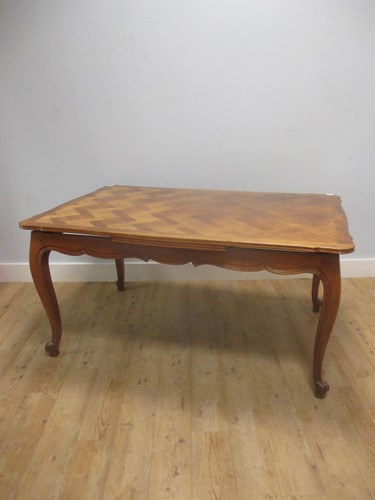 Lot 427 - A French extending dining table with two...