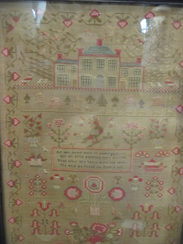 Lot 220 - A Victorian sampler with a design of a house,...