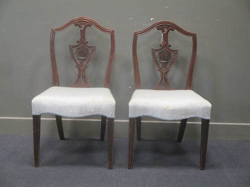 Lot 311 - A pair of Georgian chairs with shaped back and...