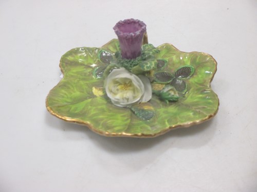 Lot 54 - A Rockingham porcelain taper stick in the form...