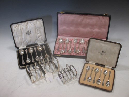 Lot 183 - Two silver toast racks and two cased sets each...