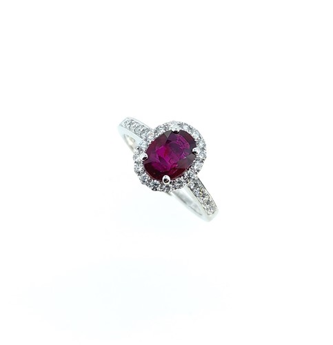 Lot 255 - An 18ct gold Burmese ruby and diamond halo style cluster ring
