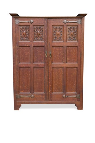 Lot 221 - Attributed to Shapland & Petter, an Arts & Crafts oak hall cupboard, circa 1905