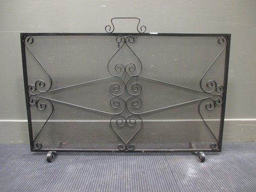 Lot 438 - A wrought iron and mesh spark guard 63cm high...