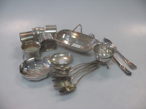 Lot 411 - A collection of silver wares including napkin...