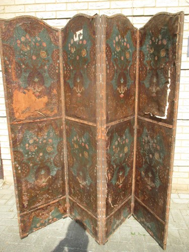 Lot 678 - A painted leather four-fold screen with floral...
