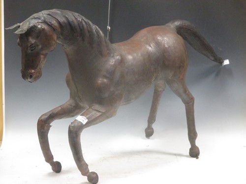 Lot 118 - Folk Art - A Leather covered wood carved horse...
