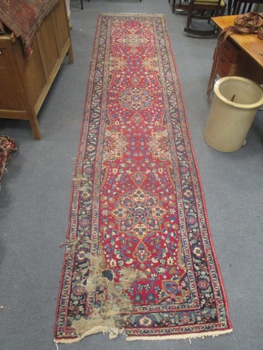 Lot 737 - A worn and damaged runner 435 x 101cm, and...