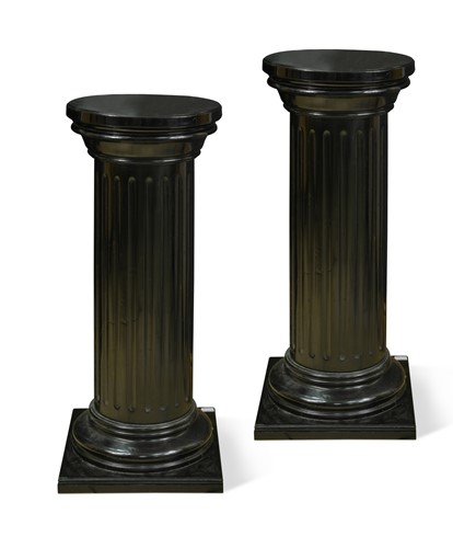 Lot 546 - A pair of ebonised fluted column pedestals