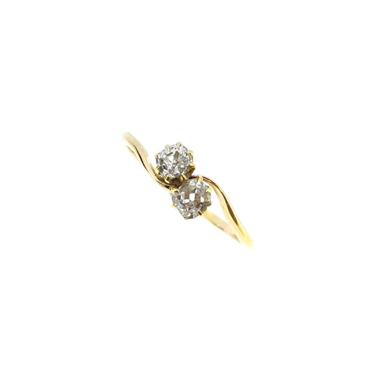 Lot 140 - A two stone diamond crossover style ring,