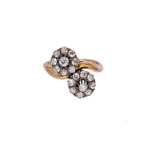 Lot 166 - A diamond set double cluster crossover style ring