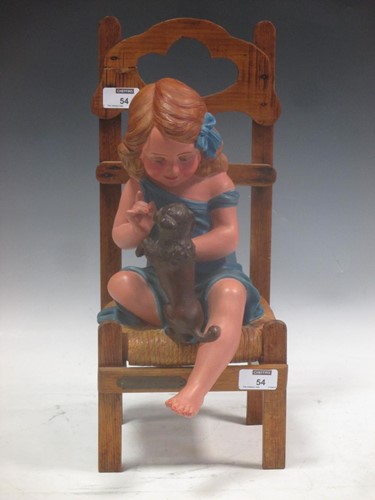 Lot 54 - An early 20th century figure, girl on chair...